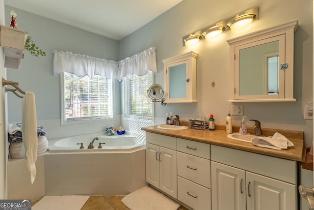 bathroom featuring tile patterned floors, vanity, and a relaxing tiled tub