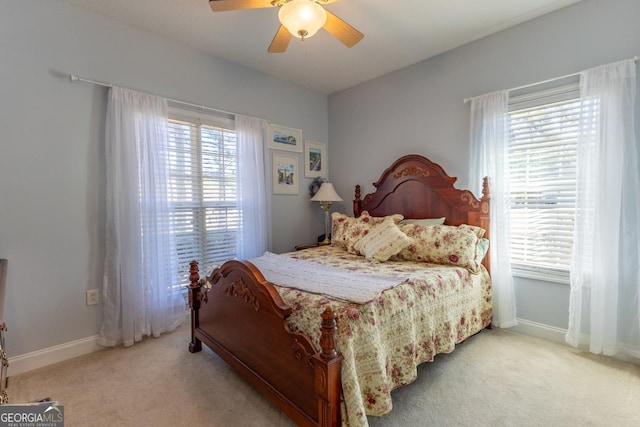 bedroom with carpet flooring, multiple windows, and ceiling fan