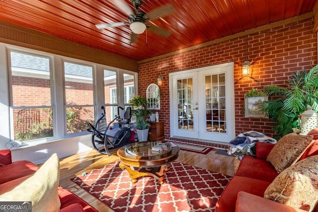 sunroom featuring ceiling fan and french doors