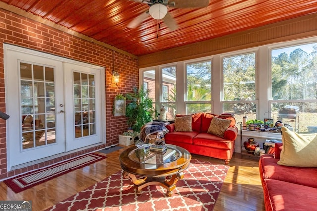 sunroom / solarium featuring french doors, ceiling fan, and a healthy amount of sunlight