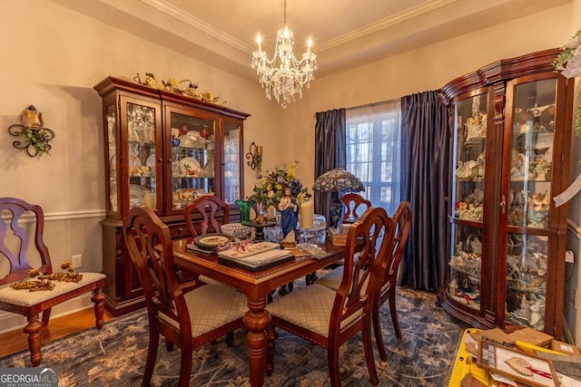 dining area featuring ornamental molding and a notable chandelier