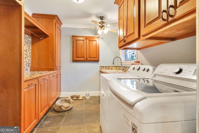 laundry area with ceiling fan, sink, cabinets, independent washer and dryer, and ornamental molding