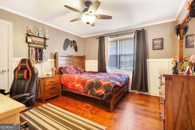 bedroom featuring ceiling fan, crown molding, and wood-type flooring