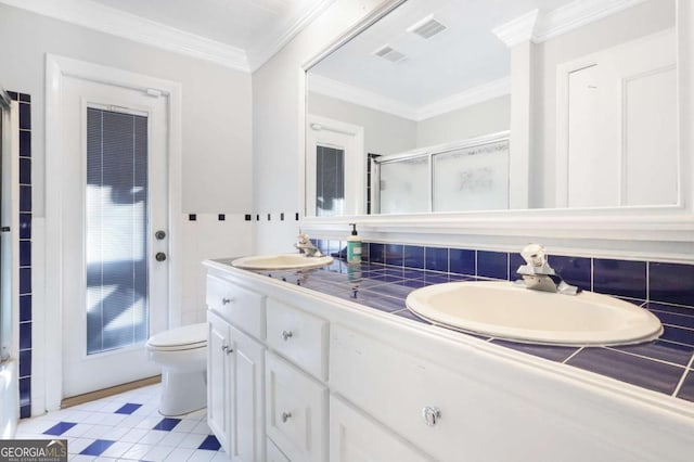 bathroom featuring backsplash, crown molding, tile patterned flooring, toilet, and a shower with shower door