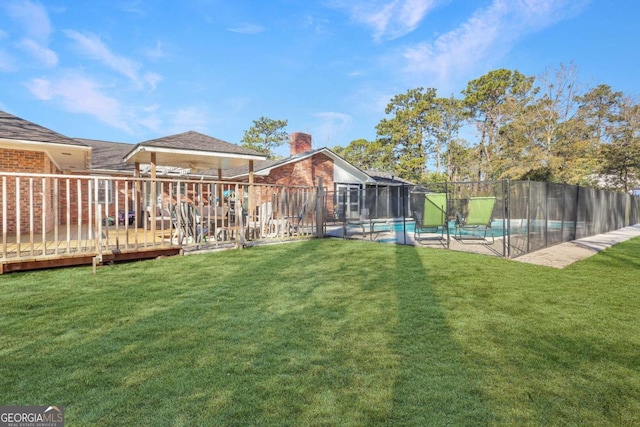 view of yard with a pool side deck