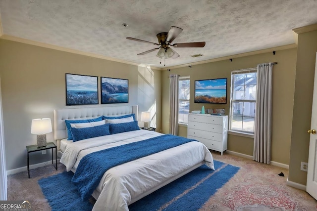 bedroom featuring a textured ceiling, ceiling fan, crown molding, and carpet