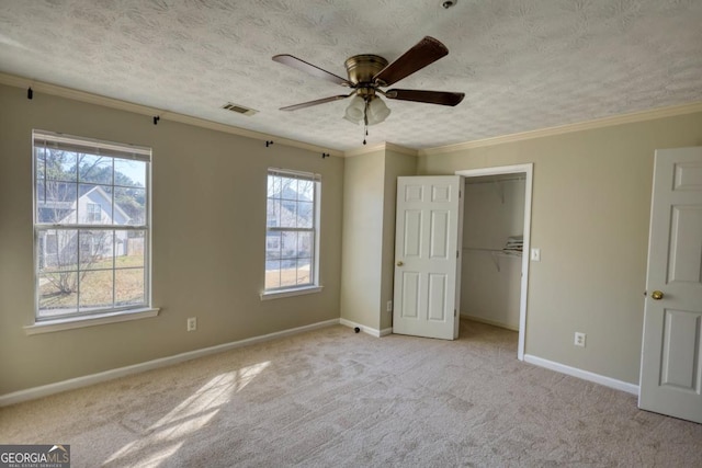 unfurnished bedroom with ceiling fan, crown molding, and multiple windows