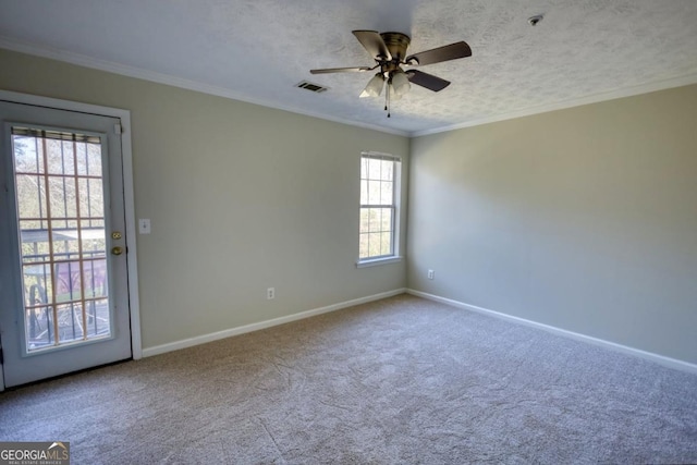 unfurnished room featuring carpet flooring, a wealth of natural light, ornamental molding, and ceiling fan