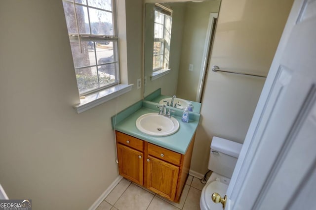 bathroom featuring tile patterned flooring, vanity, and toilet