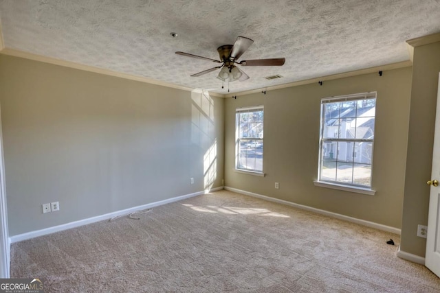 unfurnished room featuring a textured ceiling, light colored carpet, ceiling fan, and ornamental molding