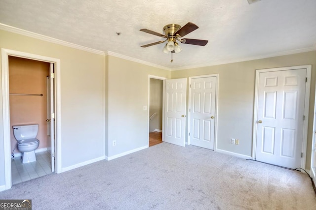 unfurnished bedroom with connected bathroom, ceiling fan, crown molding, light colored carpet, and a textured ceiling