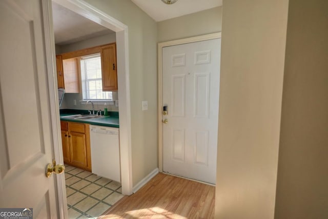 doorway featuring sink and light hardwood / wood-style floors