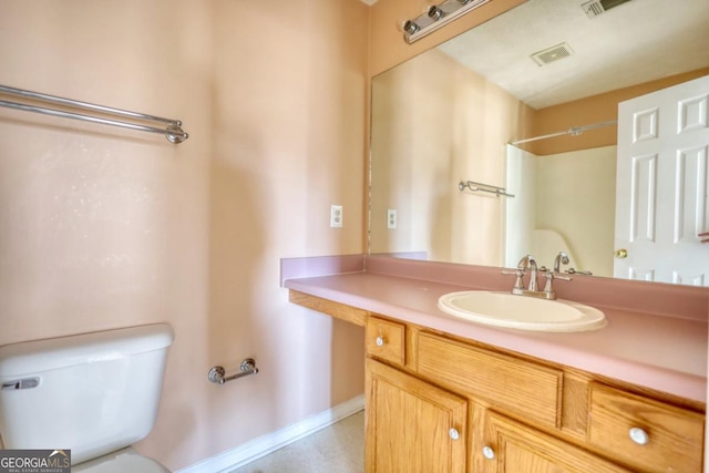 bathroom with a shower, vanity, and toilet