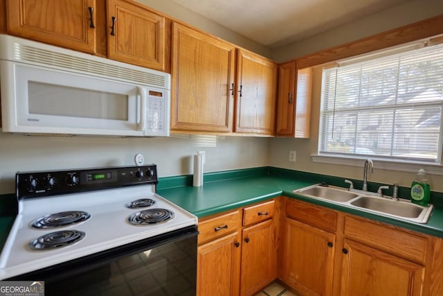 kitchen featuring white appliances and sink