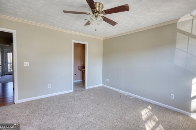 unfurnished bedroom featuring a textured ceiling, ceiling fan, ornamental molding, and carpet floors