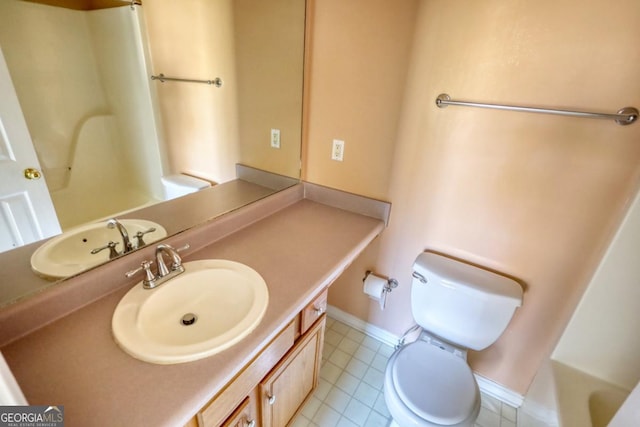 bathroom with tile patterned floors, vanity, and toilet