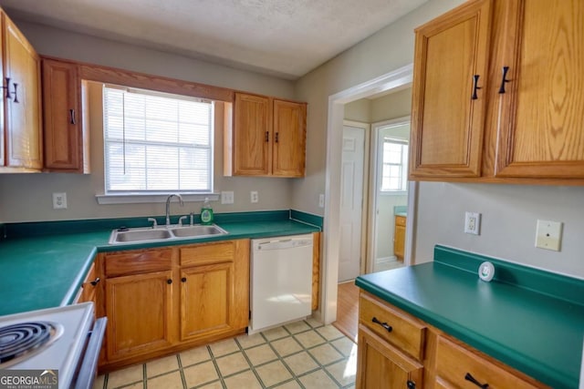 kitchen featuring a textured ceiling, sink, and white appliances