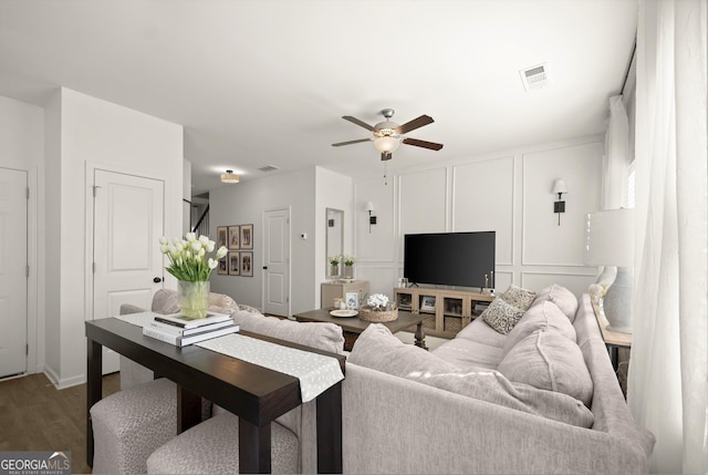 living room featuring hardwood / wood-style flooring and ceiling fan