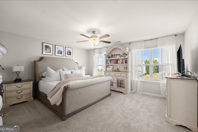 bedroom with light colored carpet and ceiling fan