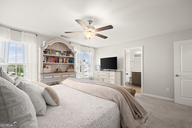 carpeted bedroom featuring connected bathroom and ceiling fan