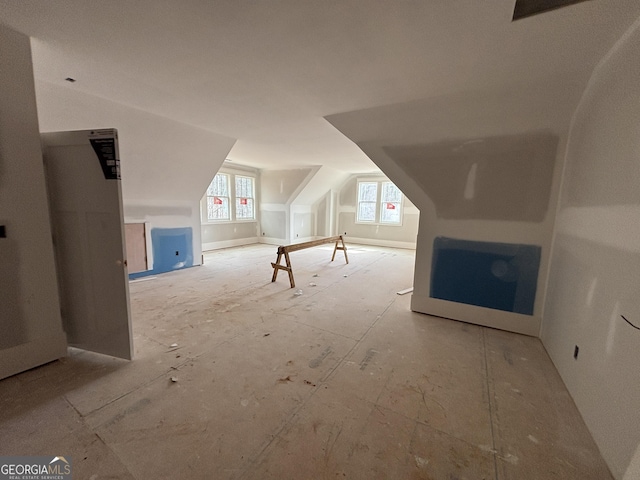 additional living space with lofted ceiling and visible vents