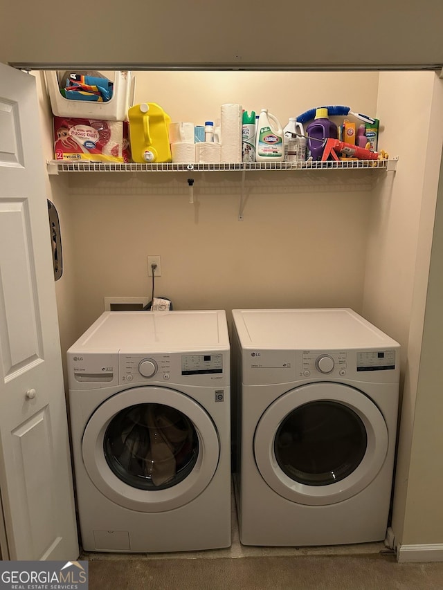 clothes washing area with carpet and washer and dryer