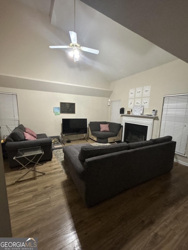 living room with vaulted ceiling, dark wood-type flooring, and ceiling fan