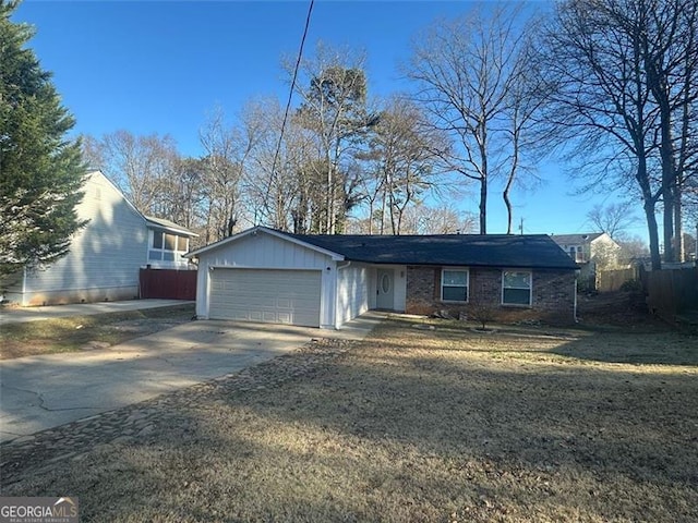 ranch-style home with a front yard and a garage