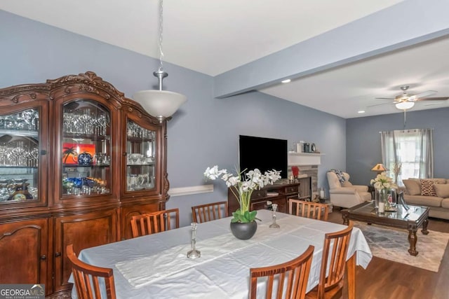 dining room with beamed ceiling, dark hardwood / wood-style floors, and ceiling fan