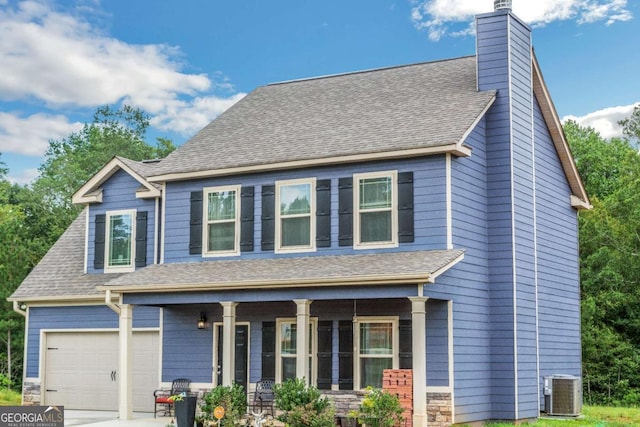 view of front of property featuring a porch, a garage, and cooling unit