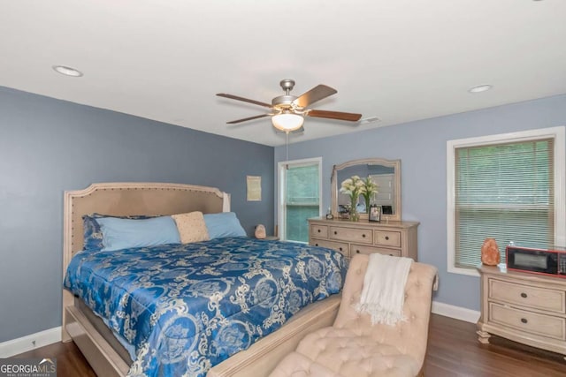 bedroom with ceiling fan and dark hardwood / wood-style flooring