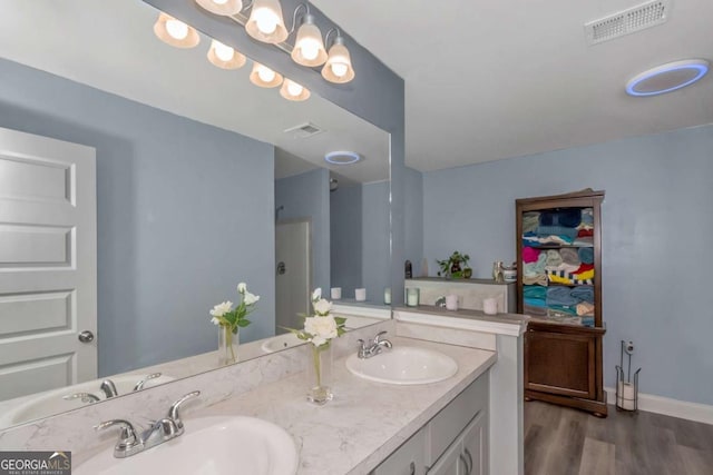 bathroom with hardwood / wood-style floors and vanity