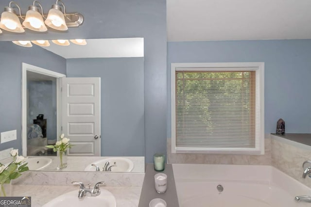 bathroom featuring a washtub and sink