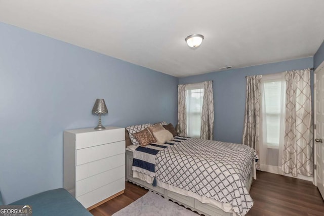 bedroom featuring dark hardwood / wood-style flooring