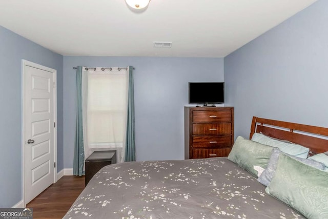 bedroom featuring dark hardwood / wood-style floors