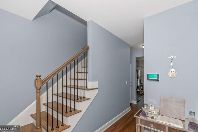 stairs featuring wood-type flooring