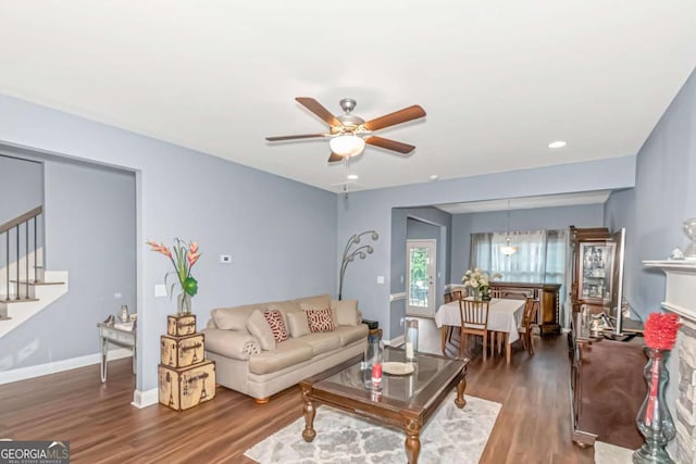 living room with ceiling fan and dark wood-type flooring