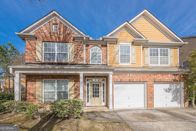 view of front of house featuring an attached garage, brick siding, and driveway