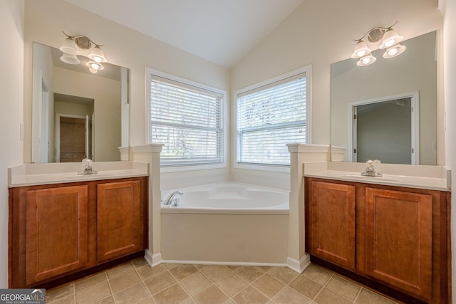 bathroom with vaulted ceiling, two vanities, and a sink