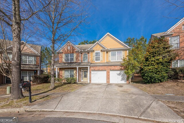 view of front facade with a garage, brick siding, and concrete driveway