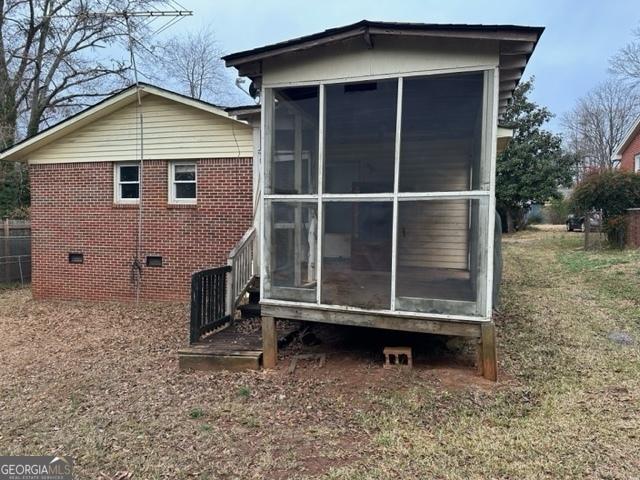 view of side of property with a sunroom