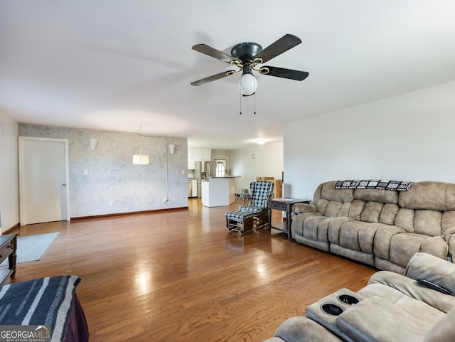 living room featuring ceiling fan and hardwood / wood-style flooring