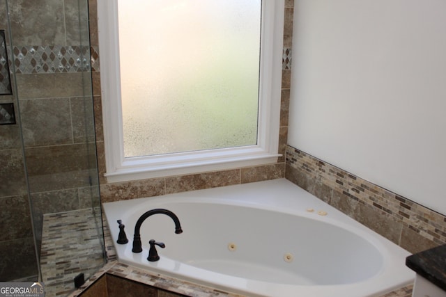 bathroom with tiled bath