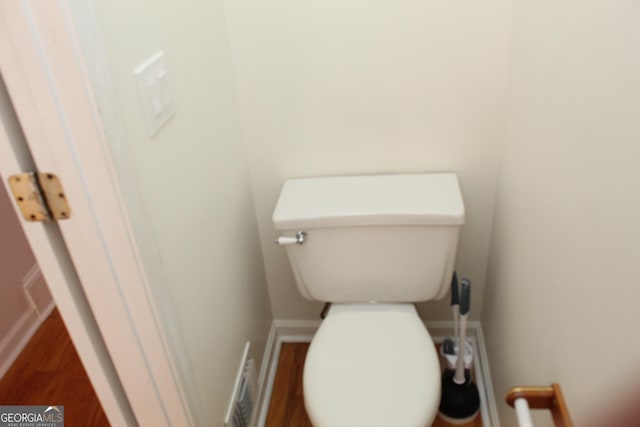 bathroom featuring hardwood / wood-style flooring and toilet