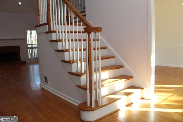 stairs featuring hardwood / wood-style flooring