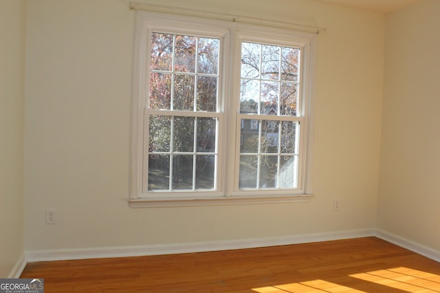 empty room with light hardwood / wood-style flooring