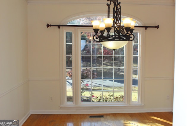 details featuring hardwood / wood-style floors and a chandelier