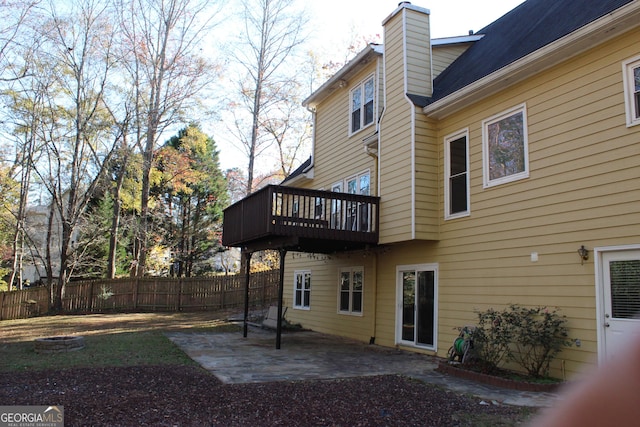 rear view of house featuring a balcony and a patio