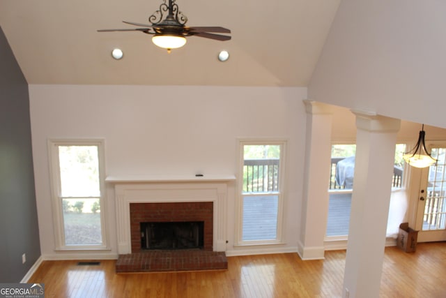 unfurnished living room featuring a fireplace, high vaulted ceiling, light hardwood / wood-style flooring, and ceiling fan