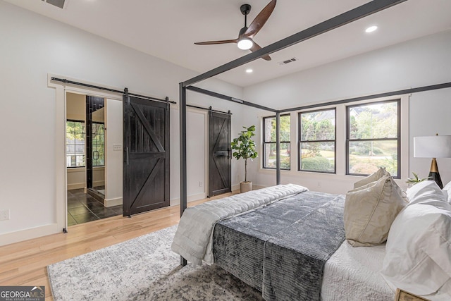 interior space with a barn door and light hardwood / wood-style floors